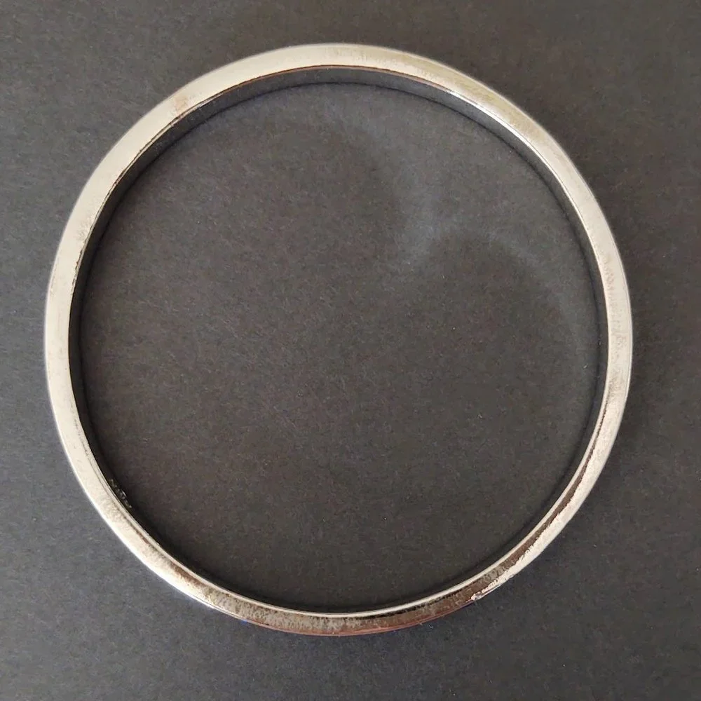 Silver bangle with inlaid blue glass beads
